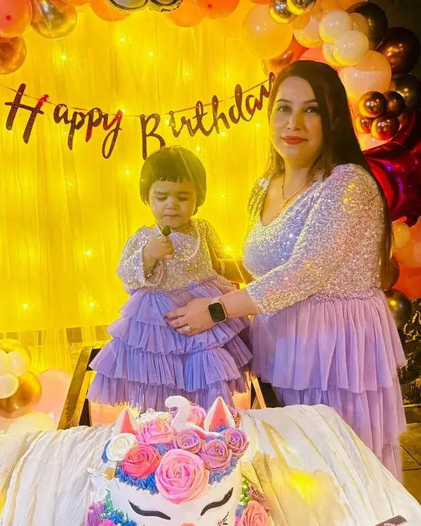 Mother and daughter wearing matching birthday outfits